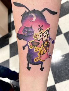 a cartoon character tattoo on the leg