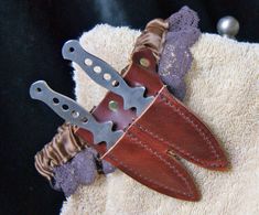 a pair of knifes sitting on top of a towel