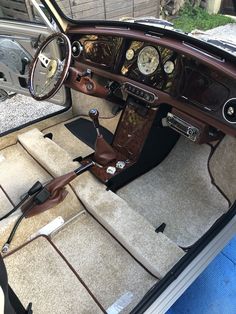 the interior of an old fashioned car with leather trims and gauges on it