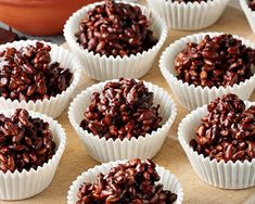 there are many chocolate candies in the cups on the table, ready to be eaten