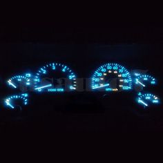 the interior of a car is lit up with blue and white lights in the dark