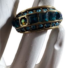 a gold ring with blue stones on it