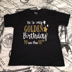 Golden Birthday Shirt! Please see the pictures for sizing, as well as for vinyl colors.  Please note, Newborn sizes only come in white. In the notes section, please include: 1. Vinyl/Writing color(s) preferred (Ex: Gold and White, Gold and Black, Etc.) 2. Age and Name for the Shirt 3. Date needed by **Free Standard Shipping. If you need your item sooner, please choose Priority Shipping during checkout which is an additional $5. If you're unsure which shipping to choose, please send me a message! Black T-shirt With Name Print For Birthday Gift, Birthday Graphic Tee Shirt With Text Print, Gold Letter Print T-shirt For Party, Black Letter Print Shirt For Birthday, Graphic Tee Shirt With Text Print For Birthday, Gold Top With Graphic Print For Birthday, Gold Graphic Print Top For Birthday, Gold Top With Graphic Print, Gold Letter Print T-shirt For Birthday