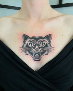 a woman with a cat tattoo on her chest