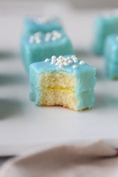 blue and yellow cake with white sprinkles on it