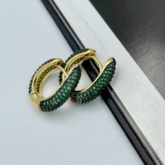 These beautiful and trendy emerald green huggie hoop earrings will make an excellent gift for yourself or friends. 18K real gold plated over brass, emerald green colored Cubic Zirconia. Measurements: Outer diameter - 17 mm Inner diameter - 10 mm These earrings would be a PERFECT GIFT for you and your family and friends! Our jewelry comes beautifully packaged in a gift box!   Click here to see more Modern Everyday Earrings: https://etsy.me/2UJldl1 Thank you for your visit! Emerald Green CZ Huggie Cheap Statement Green Hoop Earrings, Green Hoop Earrings For Party, Elegant Green Huggie Hoop Earrings, Emerald Huggie Hoop Earrings For Gift, Green Hoop Huggie Earring, Green Small Hoop Huggie Earrings For May Birthstone, Elegant Green Small Hoop Huggie Earrings, Elegant Green Hoop Huggie Earrings, Green Huggie Earrings With Matching Set