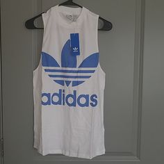 Adidas Originals Tee Condition: New Color: White/ Blue Size: S/ M One Per Order No Holds/ Trades Adidas Casual Summer Tank Top, Casual Adidas Summer Tank Top, Adidas Blue Sleeveless Top, Adidas Casual Cotton Tank Top, Casual Adidas Cotton Tank Top, Adidas Cotton Tank Top For Spring, Adidas Sporty Cotton Tank Top, Adidas Casual Sleeveless Top, Casual Adidas Sleeveless Top