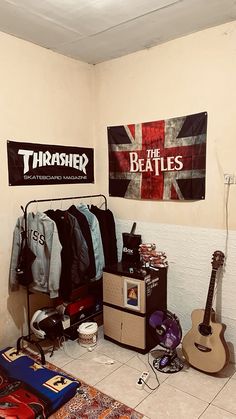 a room with guitars, clothes and other items