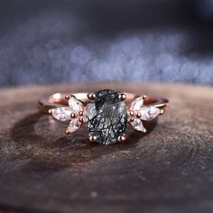 a black diamond surrounded by white diamonds on top of a piece of wood