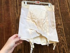 40s or 50s lace up garter belt/skirt size 34 by Sarong. Side metal zipper and stretch.  Condition - good used.  Measurements taken across front laid flat  15" across front of waist stretches to 18" 17.5" across front of hip stretches to 20" 18" length White Garter Belt, White Garter, White Garters, Belt Skirt, Hip Stretches, Waist Stretches, Skirt Belt, Metal Zipper, Sarong