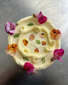 a cake decorated with flowers on top of a table