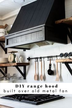 a stove top oven sitting inside of a kitchen next to wooden shelves with utensils hanging from it