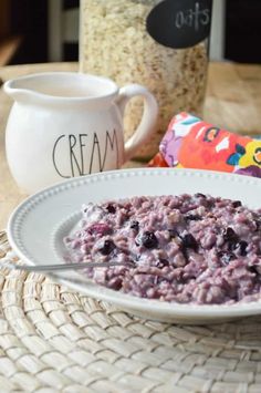 blueberries and cream oatmeal in a white bowl