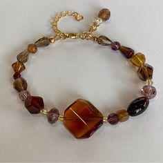 Amber Crystal And Czech Glass Beaded Bracelet From Desert Beads In 7.25" Approx. Length You Will Not Believe The Beautiful Colors In This Statement Bracelet: Amber, Gold, Dark Purple, Lavender, Honey, Champaine, Citrine, And Ruby. It Is Made With Stunning Crystals And Czech Glass Beads; It Even Has A Charm Made From The Same Beads. It Also Has One Small Piece Of Real Amber In It, Can You Guess Which One? All Strung On High Quality Jewelry Wire, It Has An Adjustable Chain, And Lobster Claw Closur Shifting Closet, Czech Glass Bead Bracelet, Nugget Bracelet, Glass Beaded Bracelet, Boho Wrap Bracelet, Lavender Honey, Amber Crystal, Brown Bracelet, Amber Bracelet