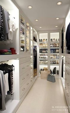 an image of a walk in closet with lots of clothes