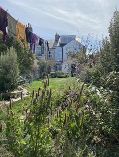 clothes hanging out to dry in the sun on a washing line outside an old house