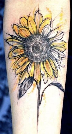 a yellow sunflower tattoo on the arm