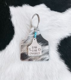 a keychain that says long live cowgirls on it's side