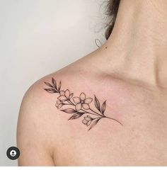 a woman's shoulder with flowers and leaves tattoo on her left side breast area