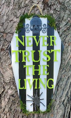 a sign that says never trust the living on a tree