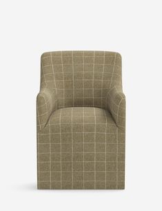 a chair that is sitting in front of a white wall with a black and brown checkered pattern on it