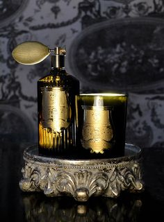 an old fashioned brass shaving set on a stand in front of a blue wall