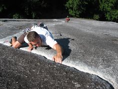 a man laying on top of a large rock