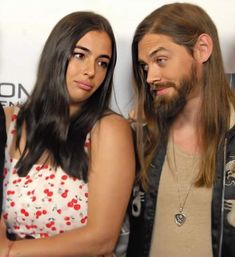 a man and woman standing next to each other