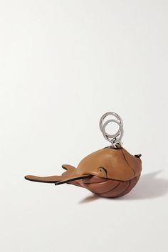 a leather keychain with a dolphin design on the front and bottom, hanging from a metal ring