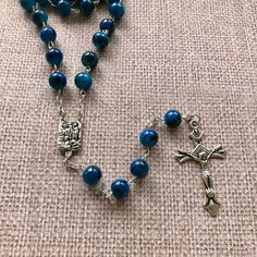 "Catholic Rosary Beads Necklace. Made and blessed in Jerusalem Holy Land Bead color: navy / multicolor Cross color - silver tone Drop length - Approximately 22\"-22.4\" ( 56-57 cm ). Approximate crucifix size -1.75\"x1\" Comes in a pouch as pictured. Silver tone metal Catholic Crucifix Cross with beautiful double sided center piece. If you have any questions, feel free to ask us. We are based in Florida and ship packages every business day very Fast and absolutely FREE! God Bless You and Your Fa Rosary Beads Necklace, Catholic Crucifix, Rosary Beads Catholic, Catholic Rosary, Rosary Catholic, Rosary Beads, Holy Land, God Bless You, Beads Necklace