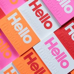 several different colored stickers with the word hello on them in red, pink, orange and white