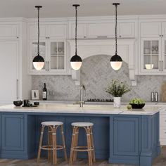 a kitchen with white cabinets and blue island