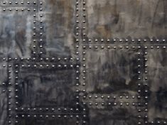 an abstract metal background with rivets and studs on the sides, including square holes