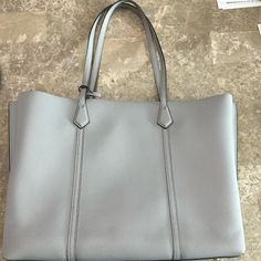 Tory Burch Perry Pebbled Leather Gray Tote Handbag No Signs Of Wear Only Used For A Short Time. Dimensions Of The Tote Are 15”Wide By 12” High Straps Are 10 1/2” Long. Includes The Duster Bag. Tory Burch Tote, Grey Tote, Tory Burch Bags, Tory Burch Bag, Tote Handbag, Womens Tote Bags, Pebbled Leather, Tote Handbags, Tory Burch