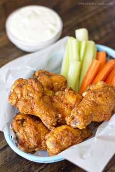 chicken wings with carrots, celery and celery sticks in a bowl