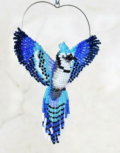 a beaded blue bird hanging from a wire