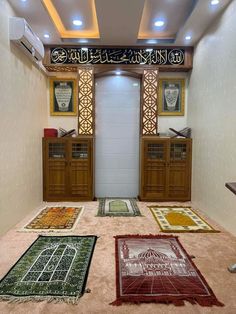 a room filled with lots of different rugs on the floor and in front of two doors