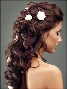 a woman with long hair and flowers in her hair