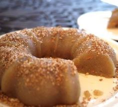 a bundt cake is sitting on a plate with powdered sugar sprinkled around it