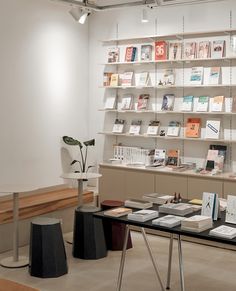 a table with many books on it in a room