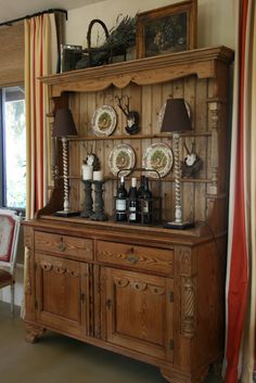 an old wooden cabinet with plates on it