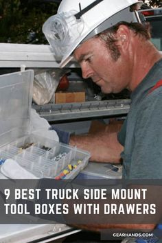 a man wearing a hard hat and holding a tool box with drawers in front of an open refrigerator