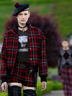 a woman in black and red plaid jacket with boots