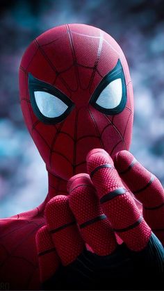 a close up of a spider man holding his hand to his face