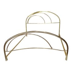 a gold metal bed frame with two circular rails on each side and one curved headboard