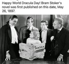 a group of men standing around a woman holding a box with dracula written on it