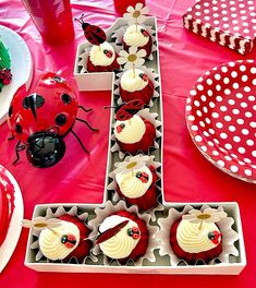 ladybug cupcakes are arranged in the shape of an x on a table