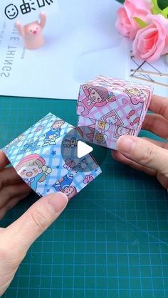 someone is making a paper doll house out of toilet paper and wrapping it up with tape