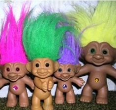 five troll dolls are lined up next to each other