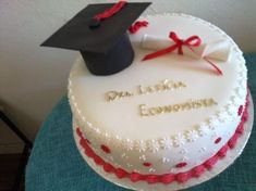 a white cake with red trim and a graduation cap on top